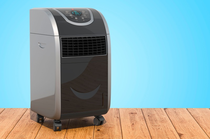 Portable air conditioner on wooden planks